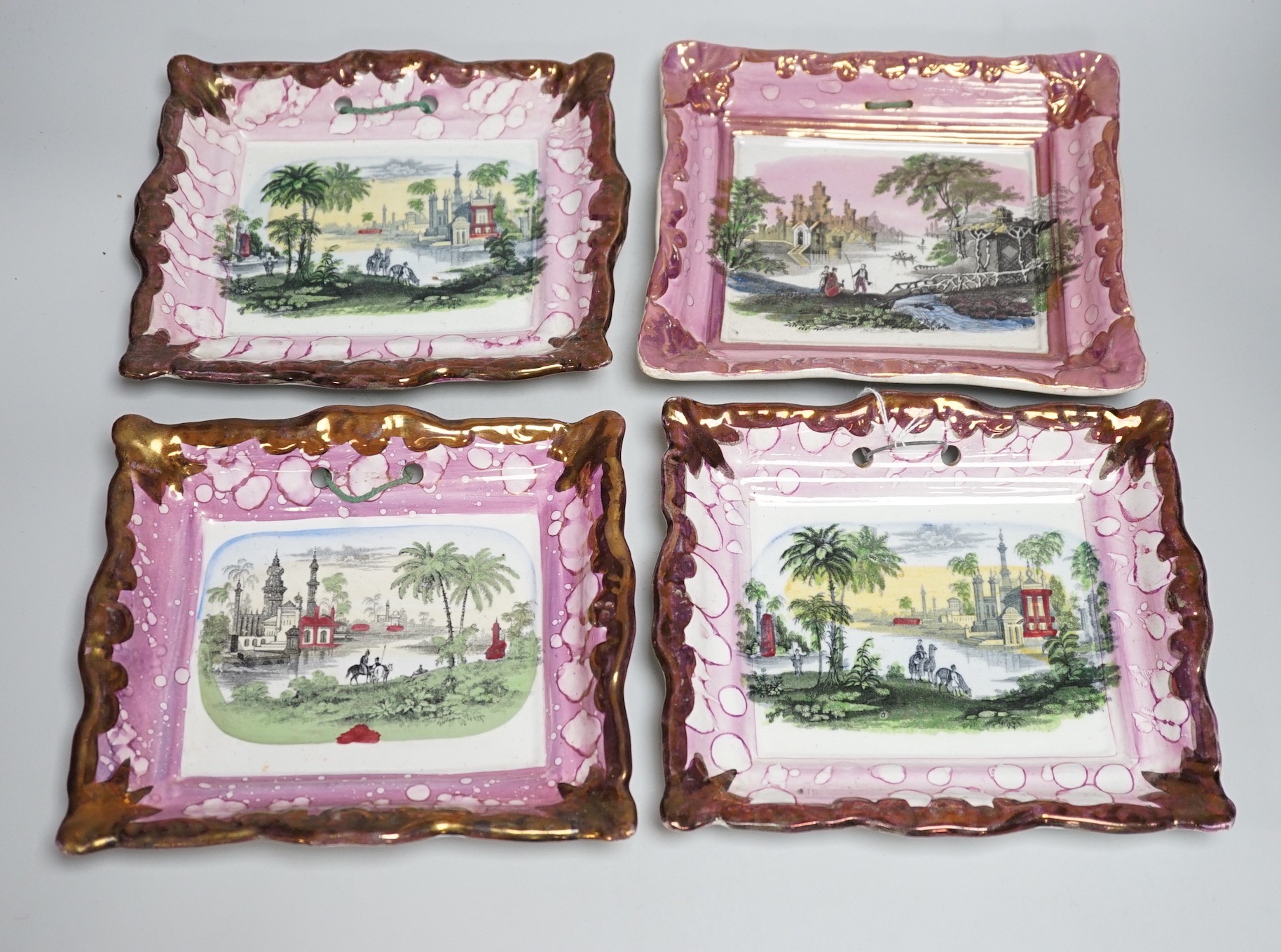 A set of four Dixon and Co. Sunderland pink lustre rectangular plaques, with copper lustre borders printed and hand coloured, impressed marks, 22cm wide
